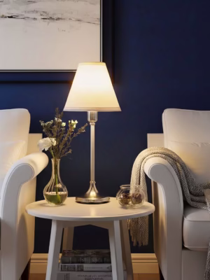 Elegant living room setup featuring IKEA Table Lamp FLYGHÖJD casting a warm glare-free glow on a white side table